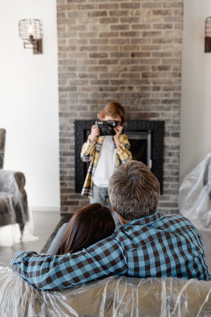 Family enjoying their new living room as a child takes a photo. A warm and cozy moment.
